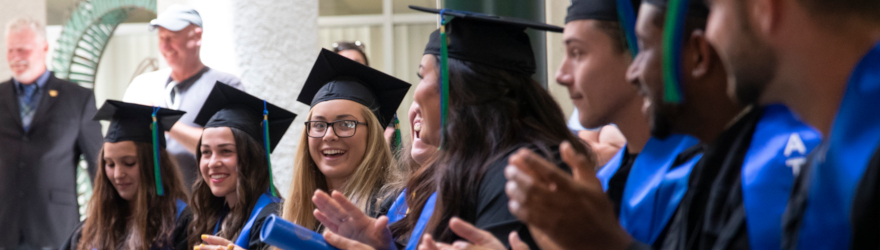 2019 graduates sit in building 10 during the spring athletics graduation ceremony
