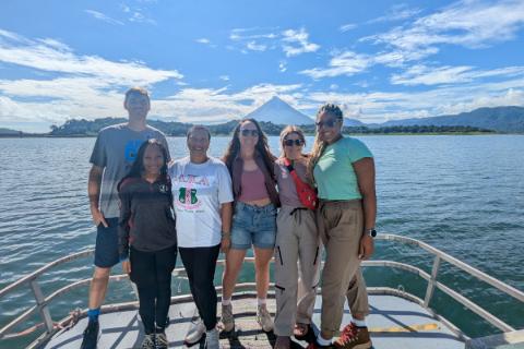 A small group of travelers pose on the boat during a dolphin cruise in the Gulf of Mexico