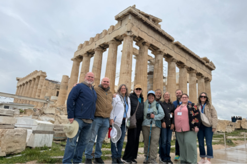 The UWF group stands in front of the ancient ruins of the Parthenon building on top of the Acropolis.