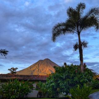 A large volcano is in the distance looking out over the jungles of Costa Rica.