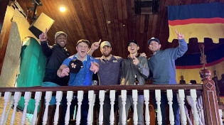 A group of SAE alumni at Seville cheering on the Argos