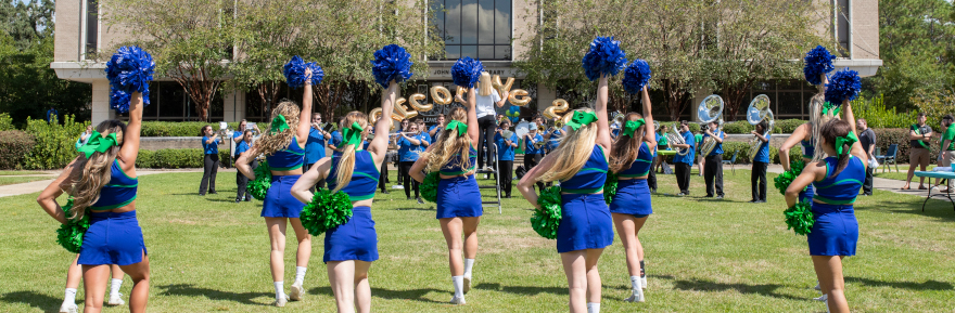 UWF Cheerleaders perform a routine on the cannon green