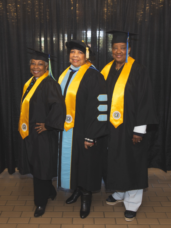 Three Golden Graduates pose together for a photo backstage during the 2024 celebration.