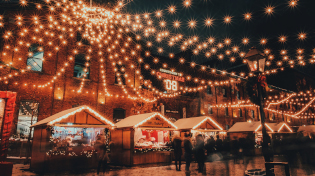 A Christmas Market in Europe with shops and white string lights