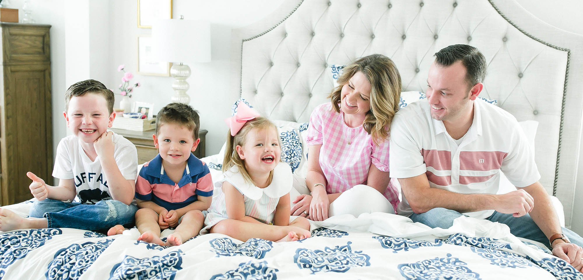 Emily Ley and family smiling in bed