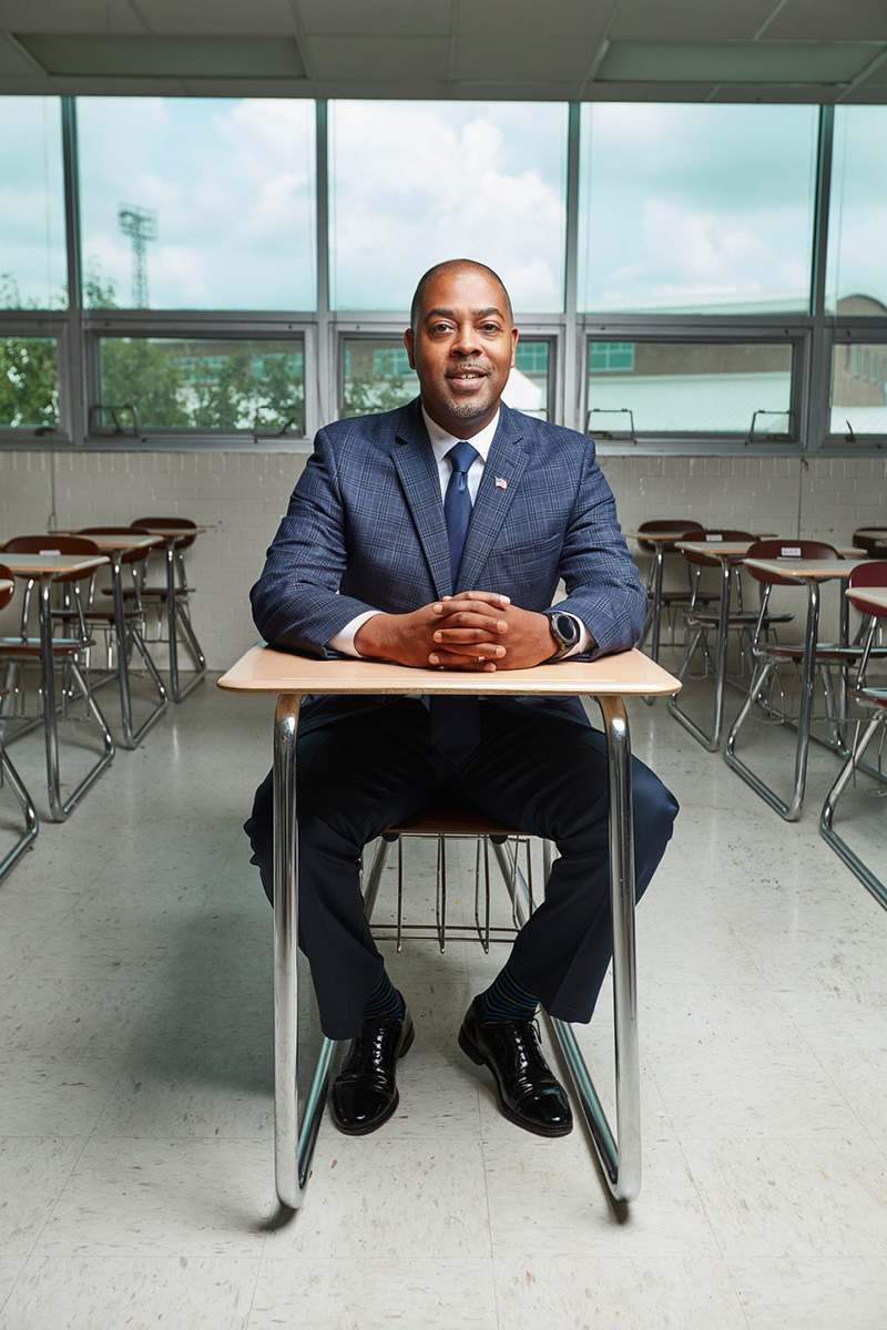 Harrison Peters seated in a student's desk