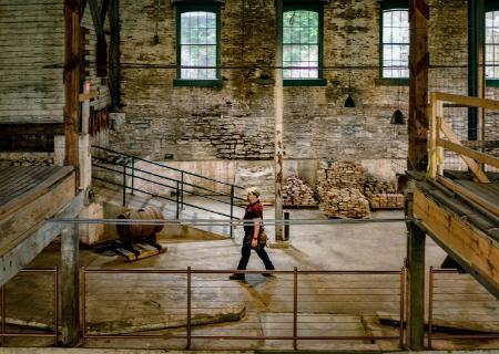 Nicolas Laracuente inside brick distillery building