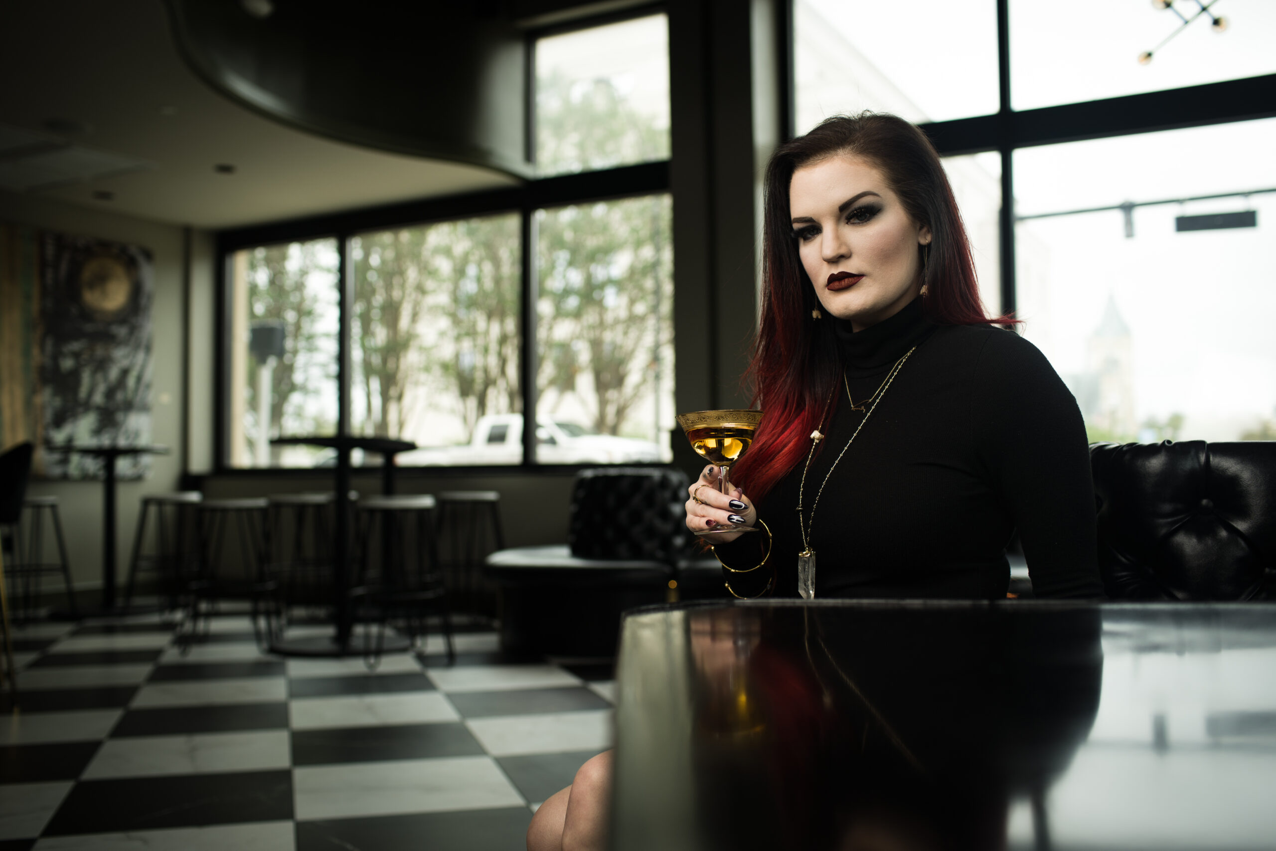 Katie Garrett holds a cocktail in The Kennedy bar