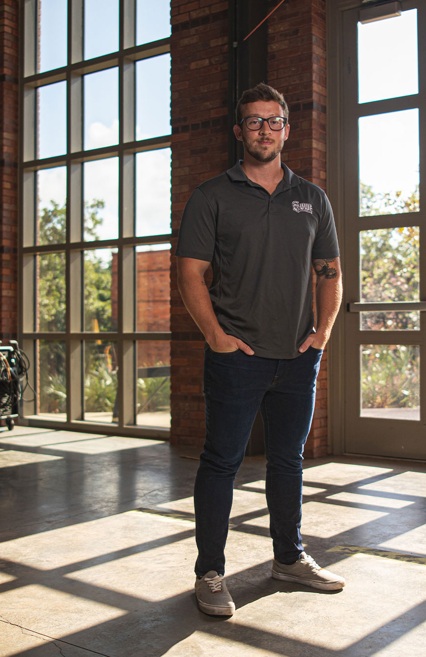 Steven Thornton standing in a room with large windows