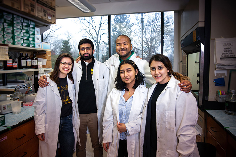 Joshua Brown smiling with a group of colleagues