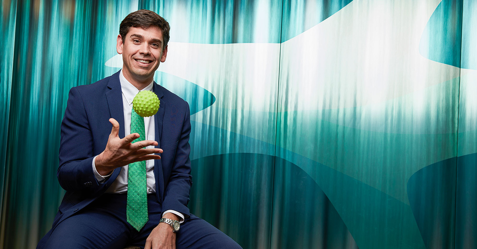 Portrait of Will Condon tossing a green squish ball