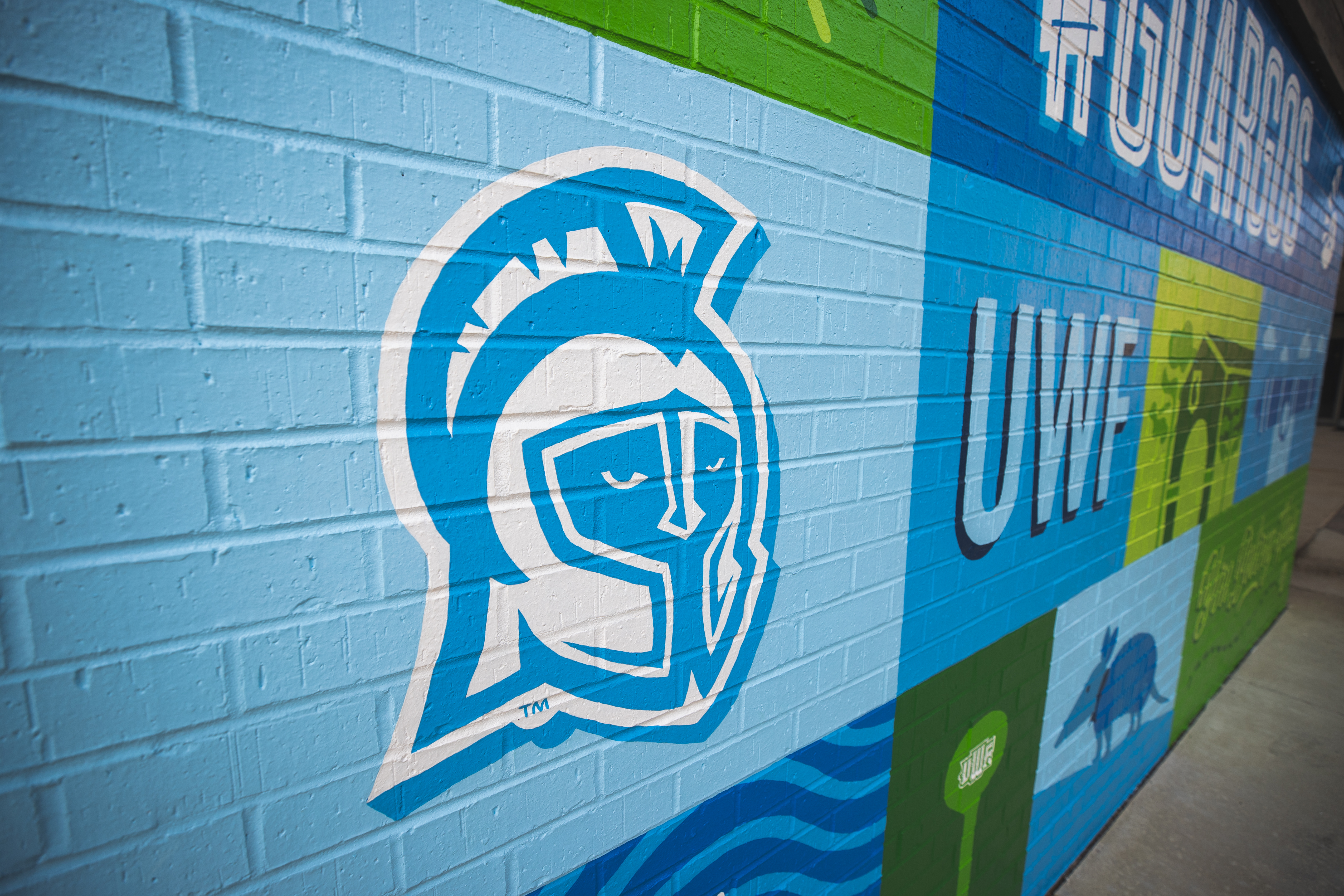 University of West Florida themed mural painted on a brick wall.