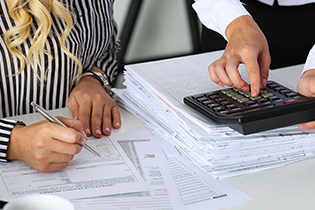 Bookkeepers reviewing accounting reports 