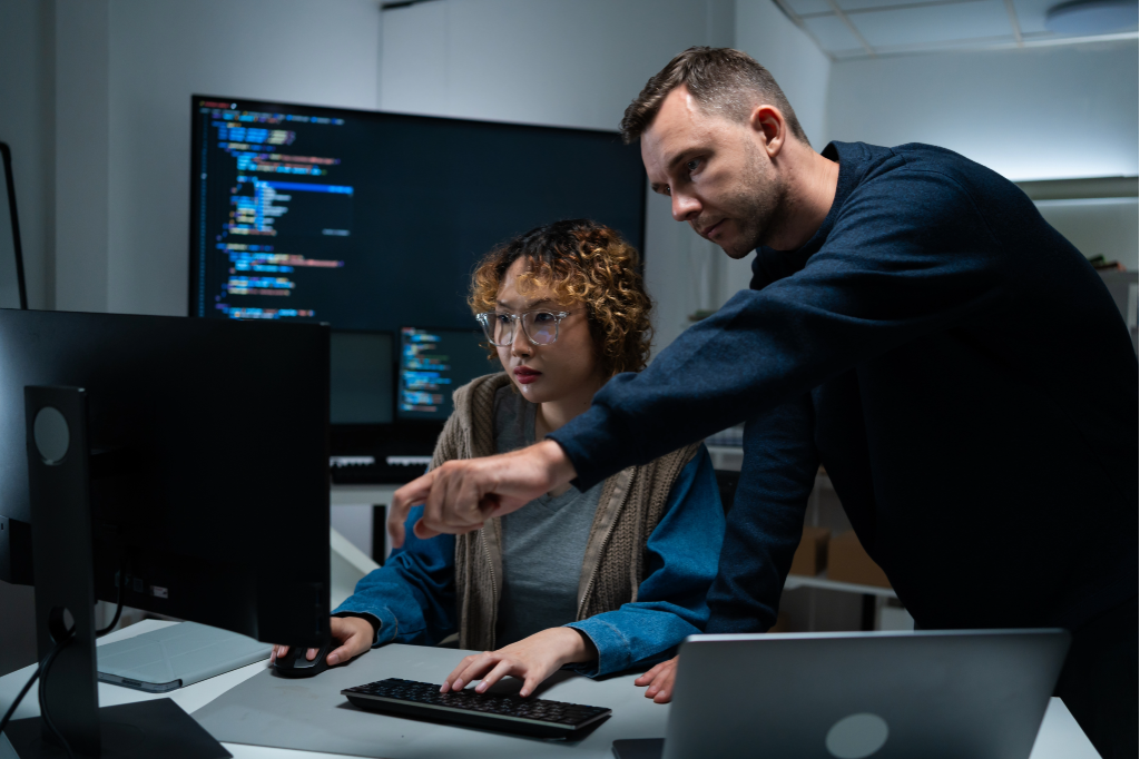 Two cybersecurity analysts working together
