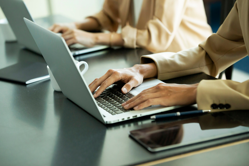 Two professionals working on their laptop