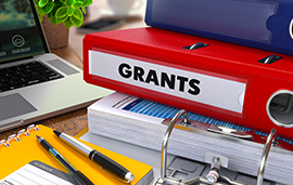 Binder for Grants on desk