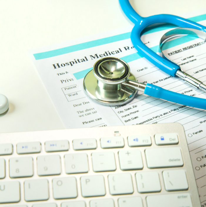 Keyboard, stethoscope and medical records