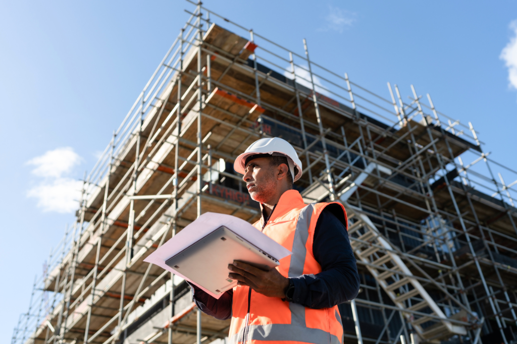 Male construction worker in front of building