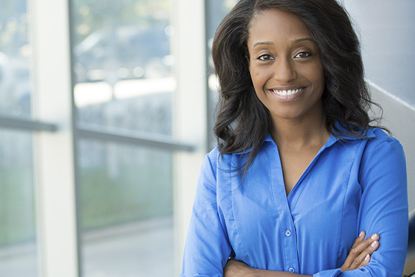 Behavior Analysis professional in office setting smiling at camera