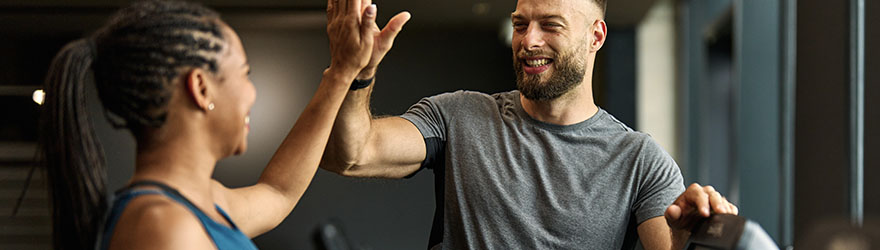 Personal trainer in gym with a client