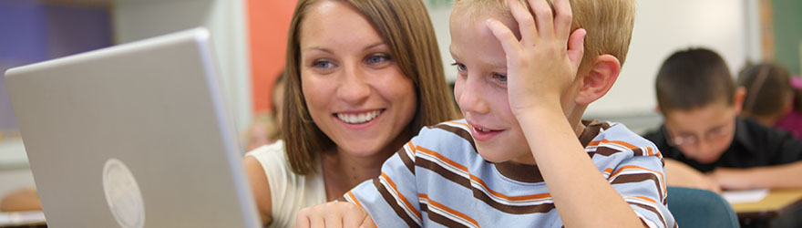 Teacher in classroom working with young students