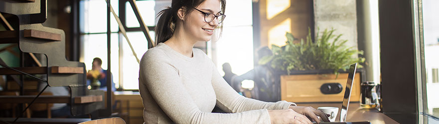 Women writing on laptop in a coffee shop