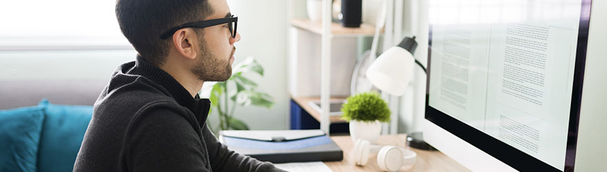 Writer at home working on desktop computer