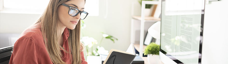 Woman reviewing notes in home office