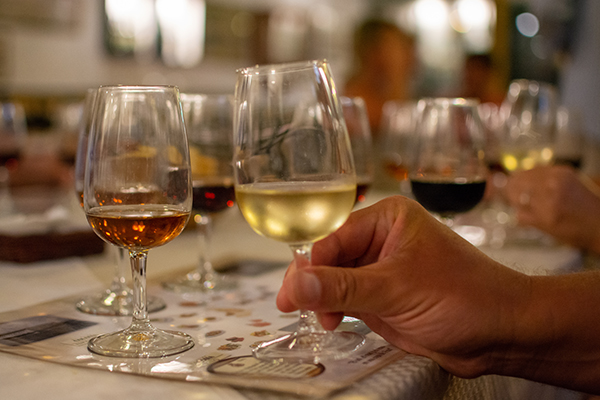 Hand holding wine glass during wine tasting class