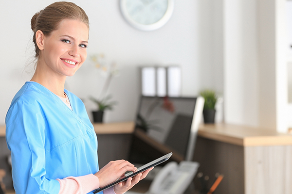 Medical Billing medical office employee smiling at the camera