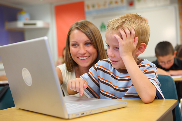 Teacher in the classroom working with student