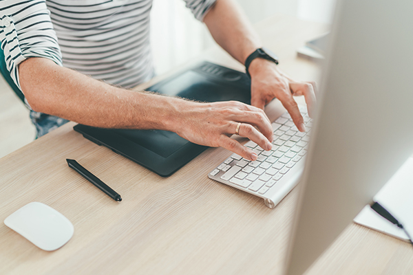 Hand on laptop typing