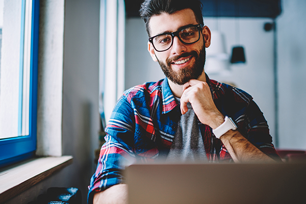 Business man sitting behind laptop
