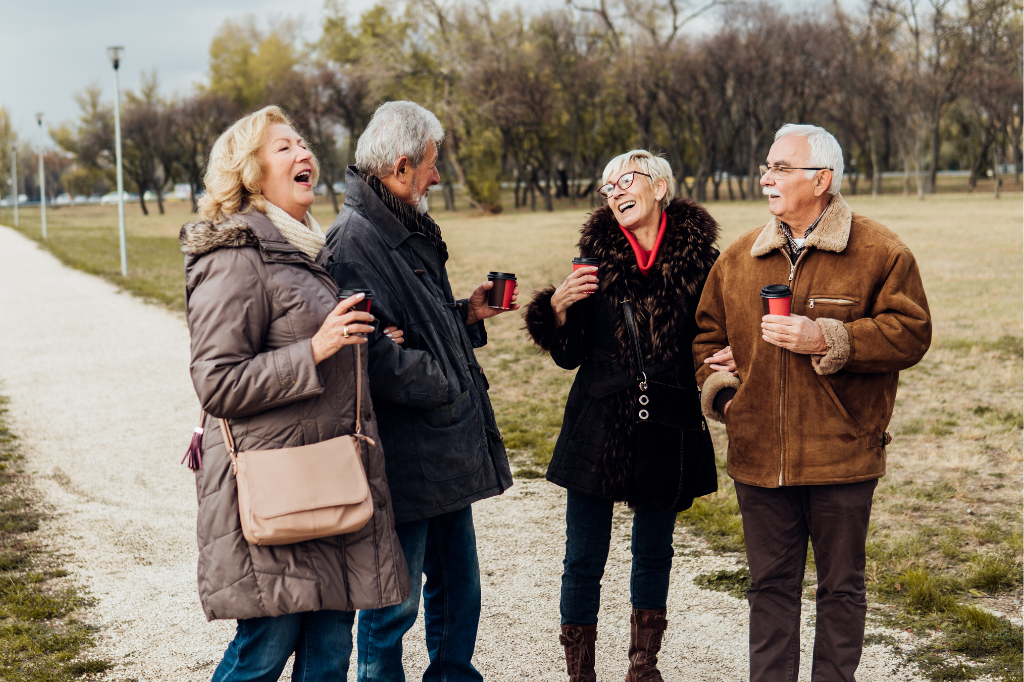 Two middle-aged couples laughing together