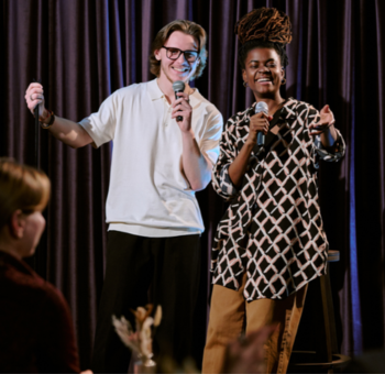 Two individuals doing improv on stage