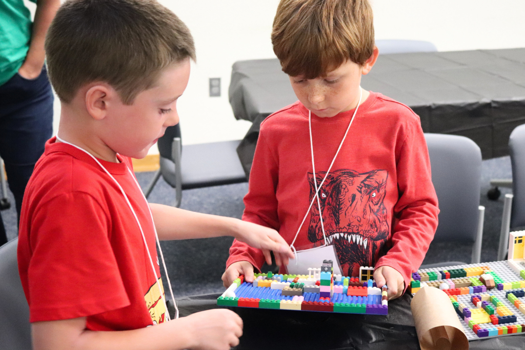 Two children building legos