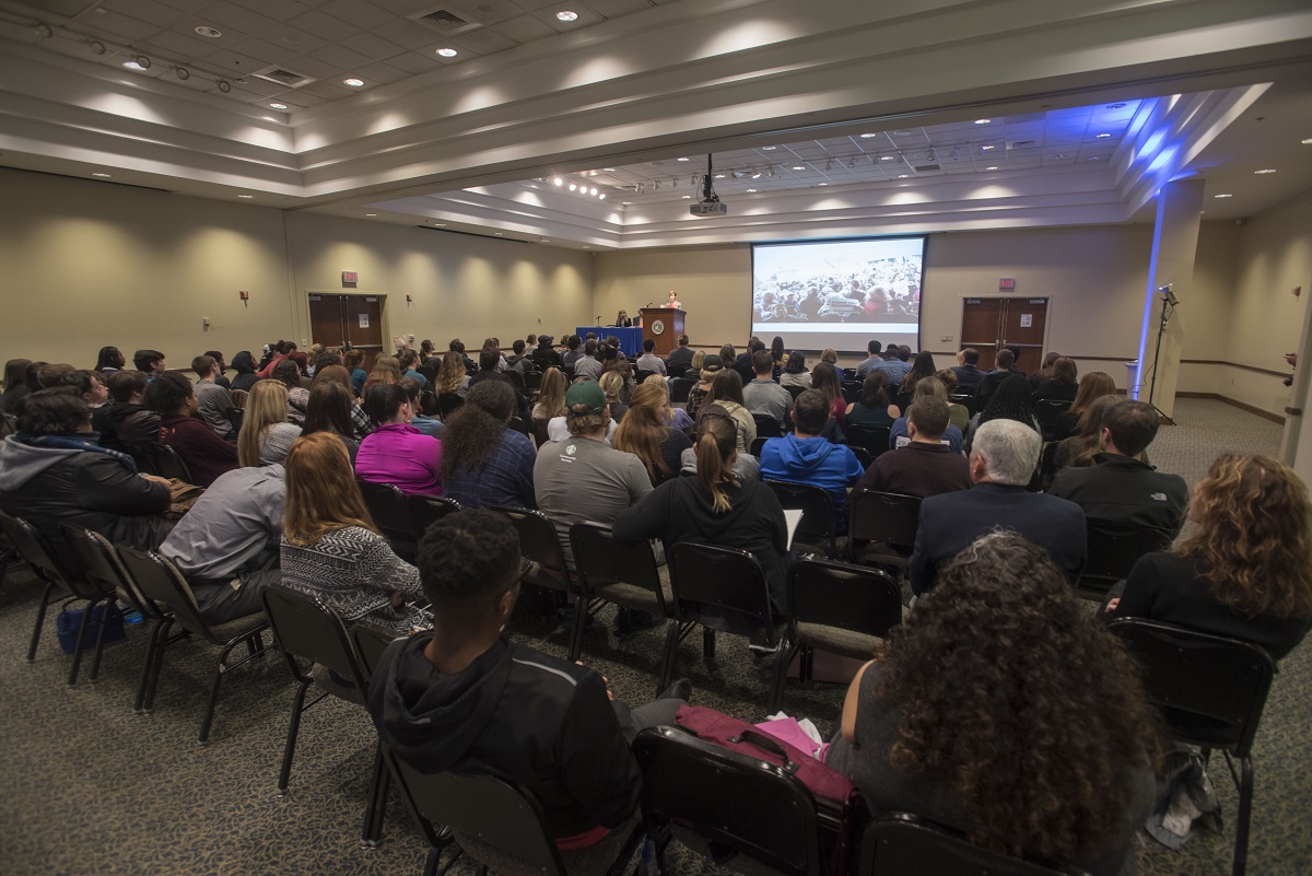 A photo of an audience listening to a lecture.