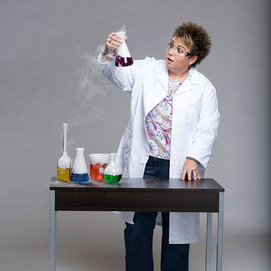 Chemistry professor examining a steaming beaker