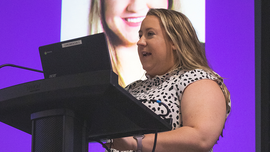 Staff member speaking at a podium
