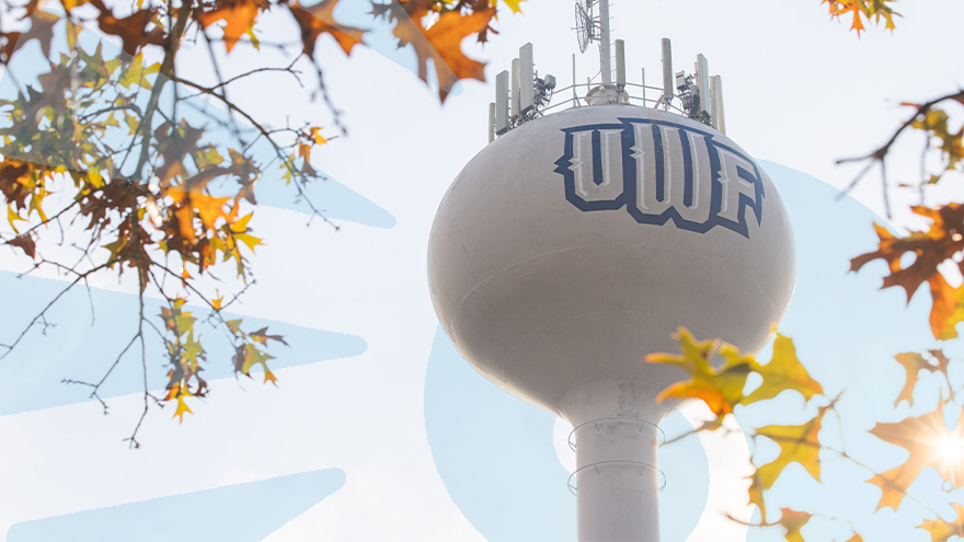 UWF water tower behind fall color leaves on the UWF Pensacola campus.