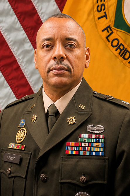 Milton Lewis indoor headshot in military uniform attire with the United States flag and University of Florida military flag in the background.
