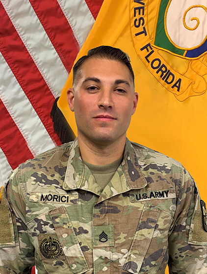 Dominick Morici indoor headshot in military uniform attire with the United States flag and University of Florida military flag in the background.