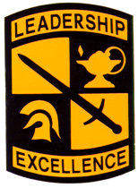 A military patch with Leadership at the top, symbols of a lamp, sword and knight helmet in the middle, and Excellence at the bottom.