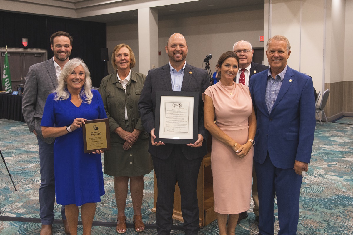 BOT members and the president presenting Senator Broxson with a resolution.
