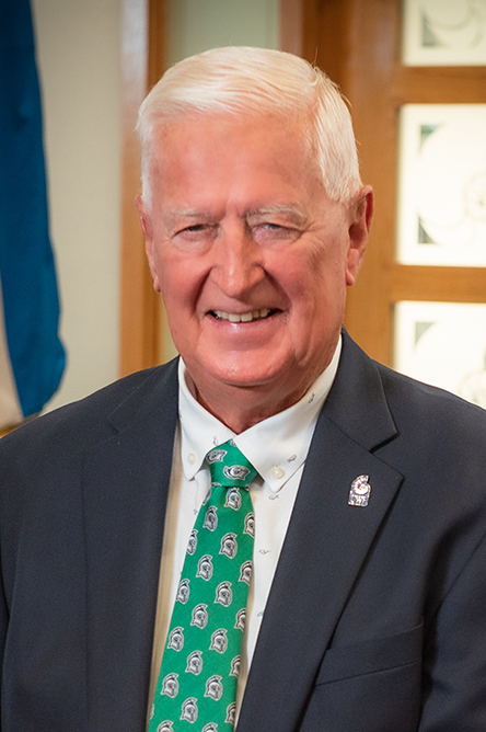 Gordon Sprague indoor headshot in suit and tie attire.