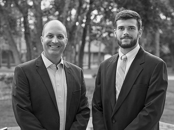 UWF Executive Mentor Program business professional mentor and UWF student mentee, both in professional attire.