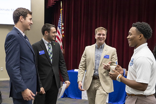 four student government association members conversing after a meeting