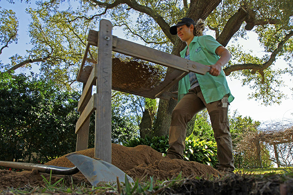 anthropology student digging at a worksite
