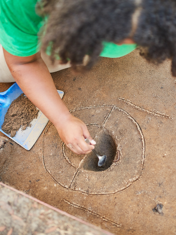 UWF archaeology student working at an archaeological dig site.