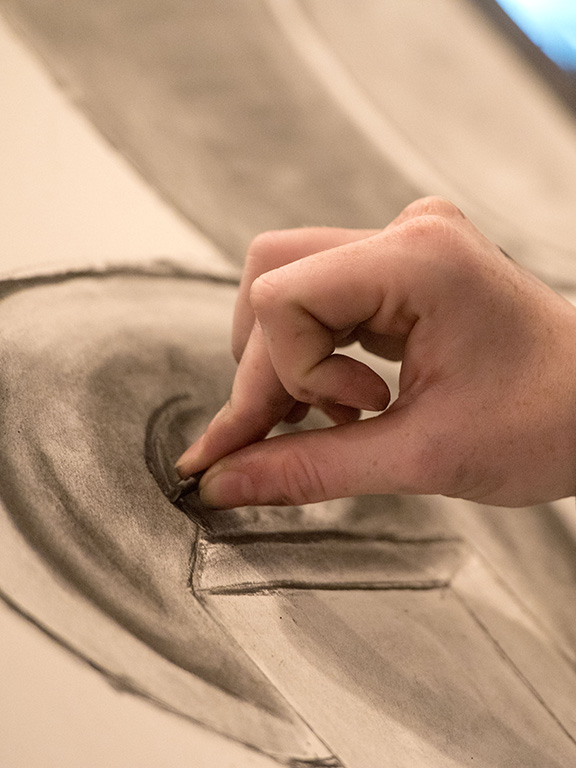 A hand drawing on a canvas with charcoal.